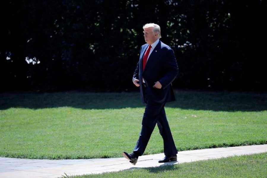 US President Donald Trump leaves the Oval Office as he departs for vacation in Bedminster, New Jersey, from the South Lawn of the White House in Washington, US, August 4, 2017. Reuters