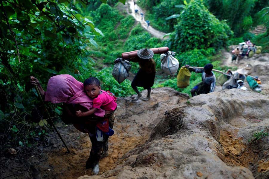 Rohingya refugees climb up a hill after crossing the Bangladesh-Myanmar border in Cox's Bazar, Bangladesh September 8, 2017. -Reuters Photo