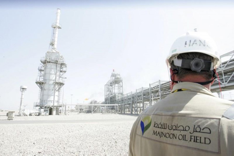 A worker walks through the Majnoon oilfield in Basra, 420 km southeast of Baghdad. 	— Reuters