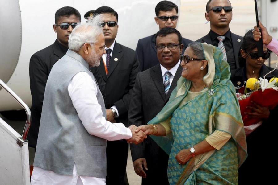 Prime Minister Narendra Modi shakes hands with Bangladesh's Prime Minister Sheikh Hasina at Shahjalal International Airport in Dhaka June 6, 2015. Reuters