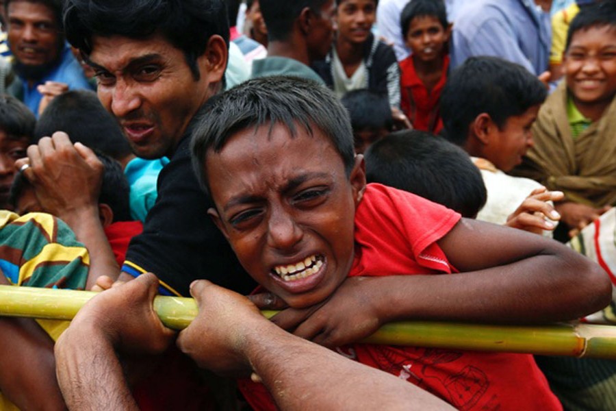 A Rohingya refugee boy jostles for aid in Cox's Bazar, Bangladesh September 20, 2017. Reuters