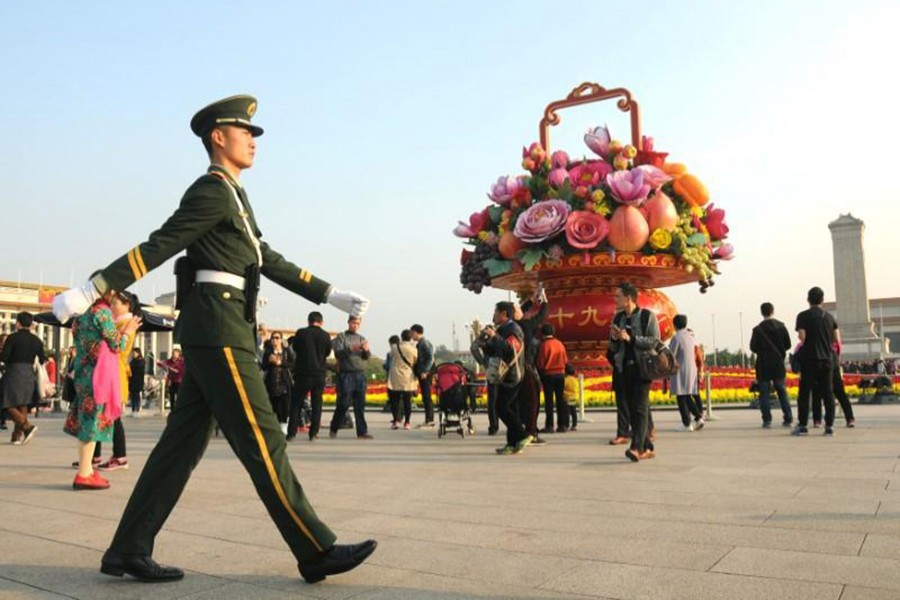 A paramilitary police officer patrols the area around Tiananmen Square ahead of the 19th National Congress of the Communist Party of China, in Beijing, China on Friday last. - Reuters photo