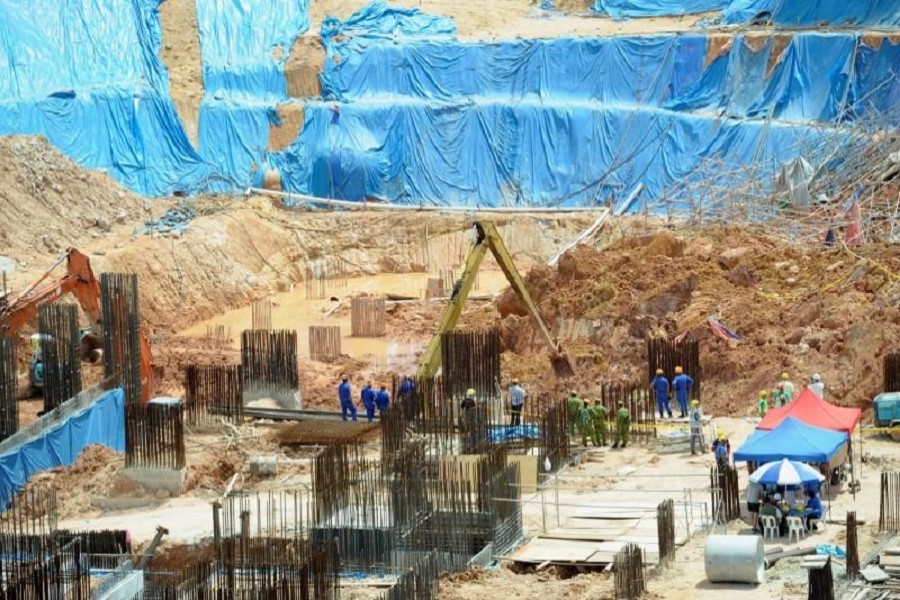 Rescue workers are seen at a construction site after it was hit by a landslide in Tanjung Bungah, Penang, Malaysia October 21, 2017. Reuters