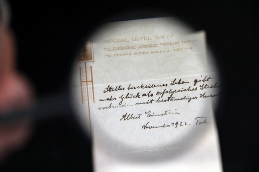 A note written on a Tokyo hotel official paper in 1922 by Albert Einstein is seen before it is sold at an auction in Jerusalem on Tuesday. - Reuters photo