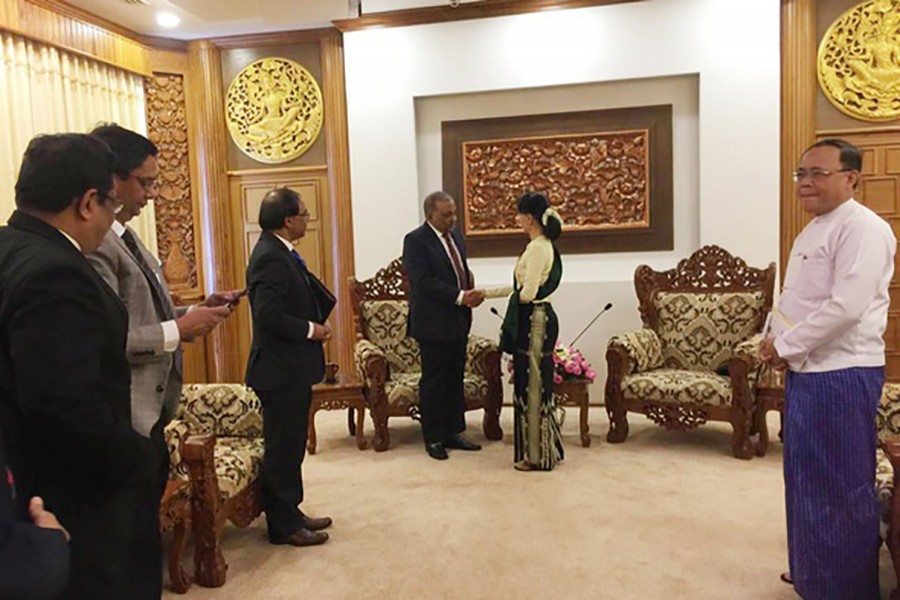 Home Minister Asaduzzaman Khan shakes hands with Myanmar Foreign Minister Aung San Suu Kyi during a meeting held at Suu Kyi's office in Myanmar's capital city on Wednesday.