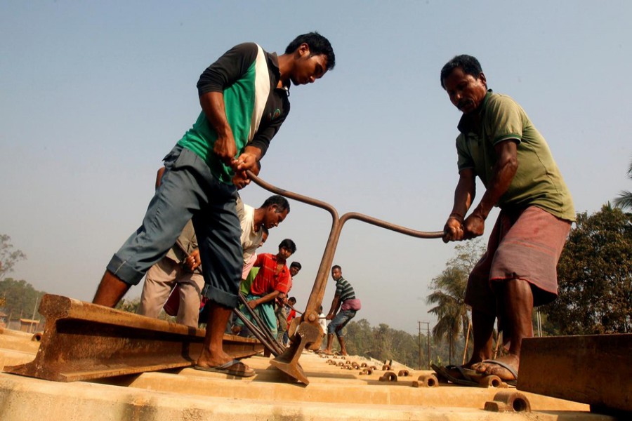 Labourers work at the installation site of a new railway track in Agartala, India. 	— Reuters File Photo