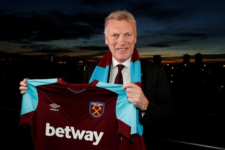 West Ham United manager David Moyes poses with the shirt after the press conference. - Reuters photo