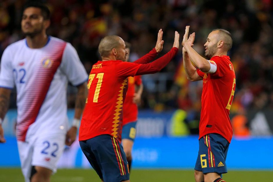 Spain’s Andres Iniesta celebrates scoring their fifth goal with David Silva. - Reuters photo