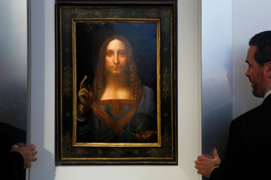 Security guards open a door to reveal Salvator Mundi by Leonardo da Vinci during a news conference at Christie's in New York. (Seth Wenig / AP photo)