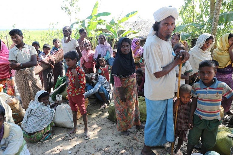 Rohingya refugees wait for vehicles to reach a refugee camp in Bangladesh November 19, 2017. Reuters