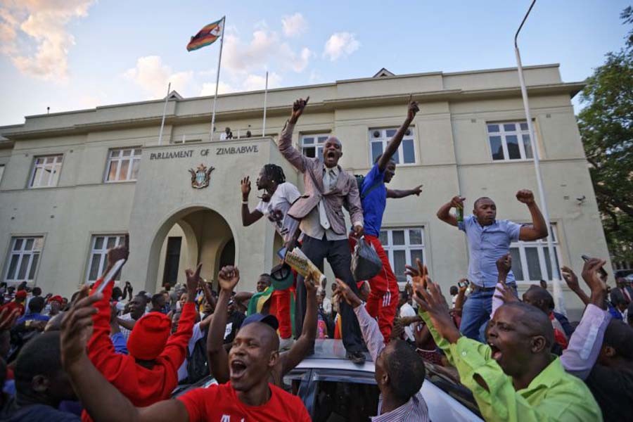 Zimbabweans celebrate outside the parliament building immediately after hearing the news that President Robert Mugabe had resigned, in downtown Harare, Zimbabwe Tuesday, November  21, 2017. —Photo:  AP