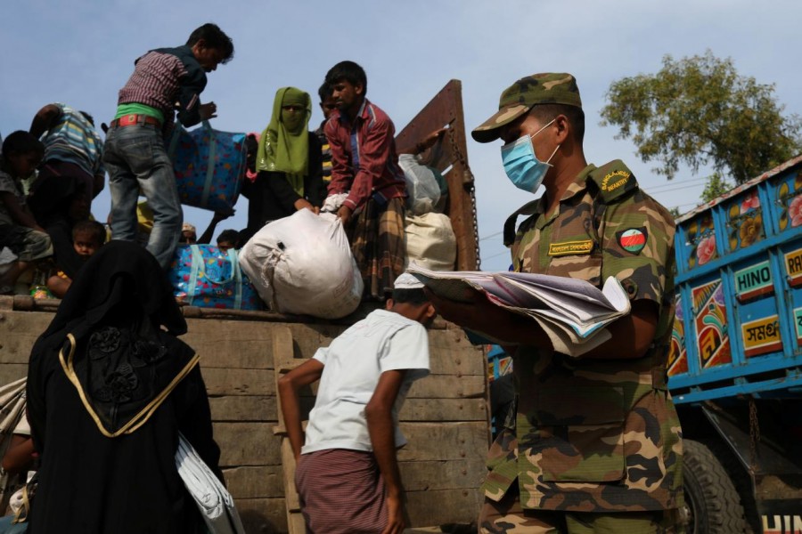 Newly arrived Rohingya refugees climb on a truck to get registered after crossing the Bangladesh-Myanmar border at a relief centre in the Teknaf area, Bangladesh, November 23, 2017. - Reuters