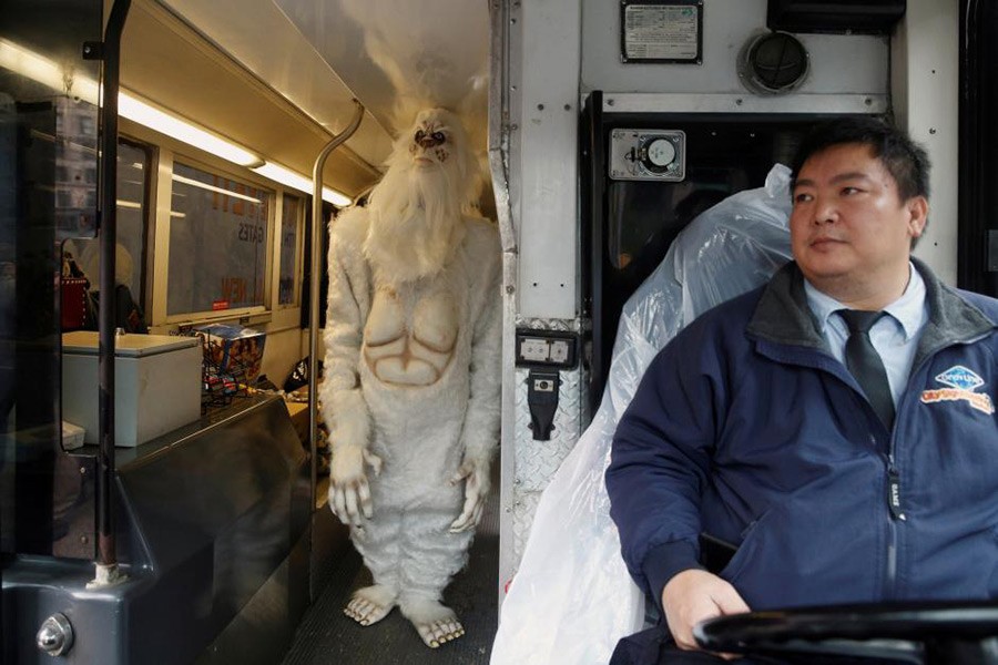 A tour bus driver watches as an actor dressed as a 'Yeti' walks on his bus during an event in Manhattan, New York City, US on October 4, 2016. - Reuters file photo