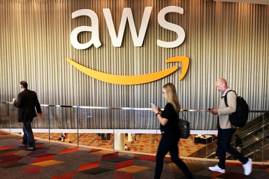 Attendees at Amazon.com Inc annual cloud computing conference walk past the Amazon Web Services logo in Las Vegas, Nevada, US, November 30, 2017. Reuters