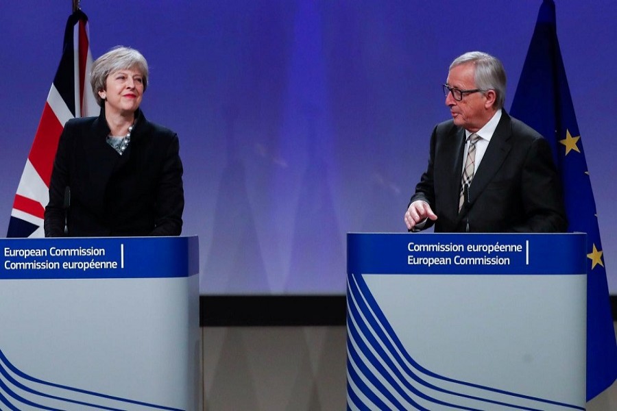 Britain's Prime Minister Theresa May and European Commission President Jean-Claude Juncker leave after making statements at the European Commission in Brussels, Belgium, December 4, 2017. Reuters