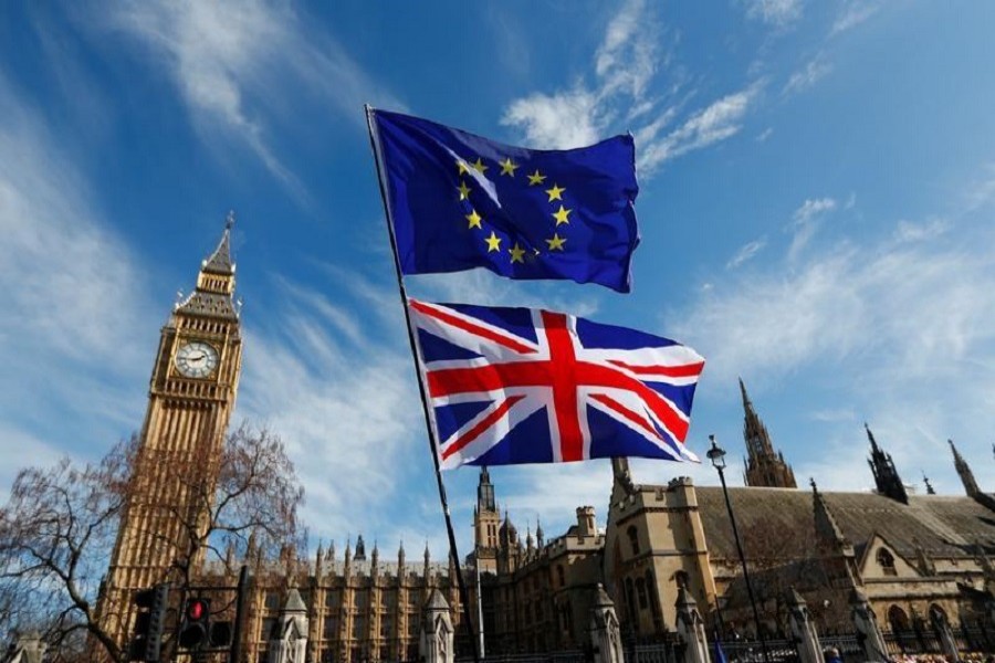 EU and Union flags fly above Parliament Square during a Unite for Europe march, in central London, Britain March 25, 2017. Reuters/File Photo