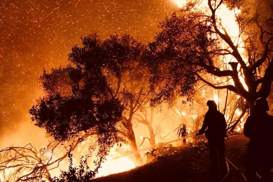 Firefighters knock down flames as they advance on homes atop Shepherd Mesa Road in Carpinteria, California, US on Sunday. - Reuters photo