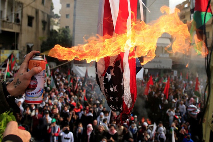 Protesters set a US flag on fire near the US embassy in Beirut, Lebanon Dec 10, 2017. Reuters