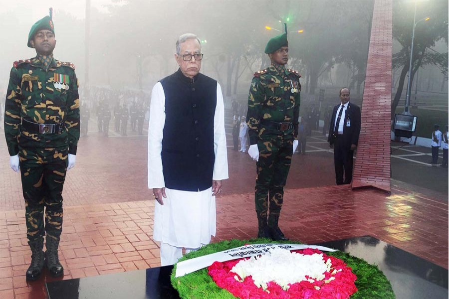 President Abdul Hamid stands in a solemn silence after placing a wreath at the Martyred Intellectuals Memorial at Mirpur in the city on Thursday on the occasion of the Martyred Intellectuals Day