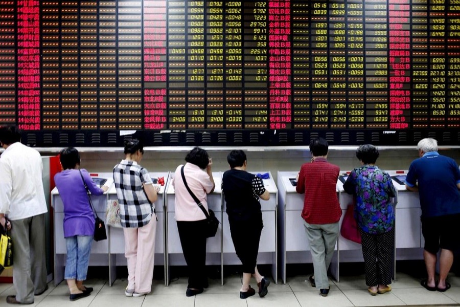 Investors look at computer screens showing stock information at a brokerage house in Shanghai, China November 24, 2017. Reuters