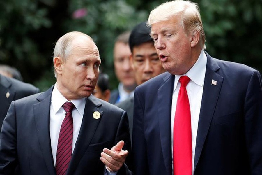 President Donald Trump and Russia's President Vladimir Putin talk during the family photo session at the APEC Summit in Danang, Vietnam November 11, 2017: Reuters