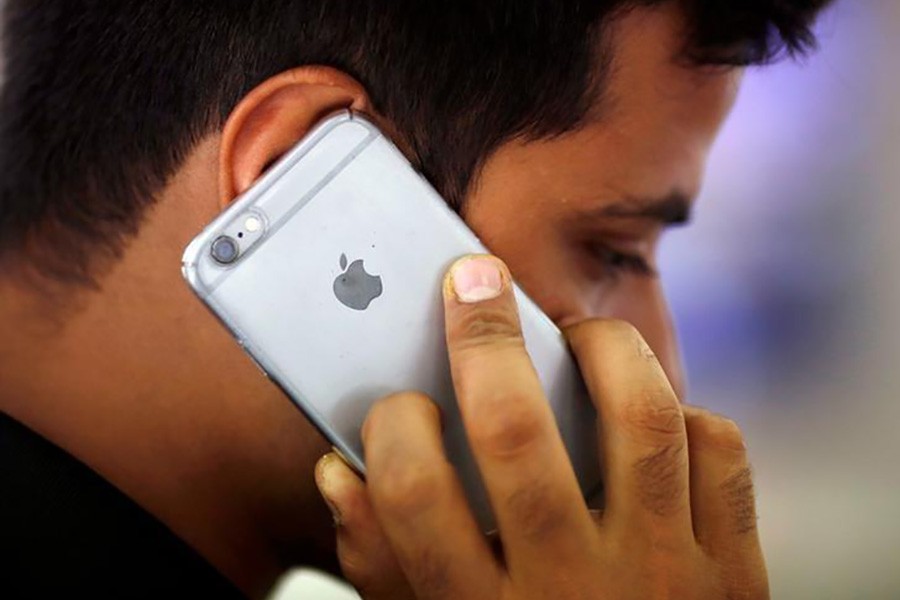 A man talks on his iPhone at a mobile phone store in New Delhi of India. -Reuters Photo