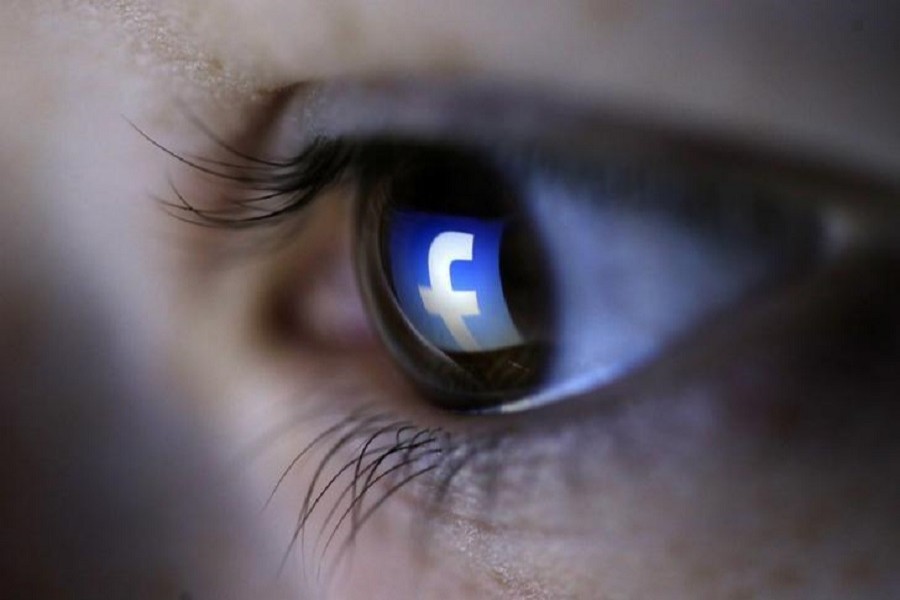 A picture illustration shows a Facebook logo reflected in a person's eye, in Zenica, March 13, 2015. Reuters/Files