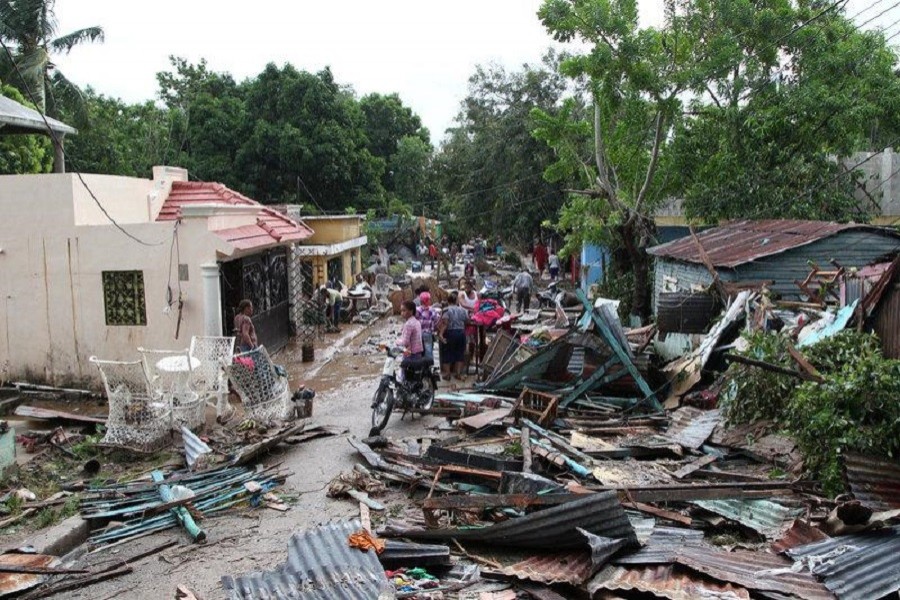 Locals stand along a street affected by the overflow of the Soco River in the aftermath of Hurricane Maria in El Seibo, Dominican Republic, September 22, 2017. Reuters/Files