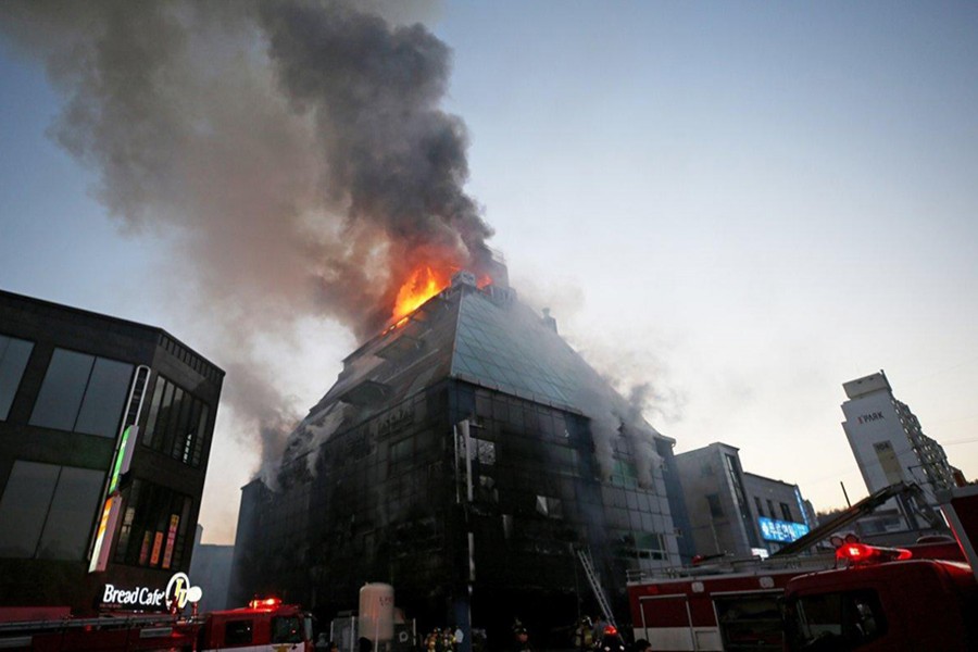 An estimated 60 firefighters battled the fire Thursday and local media showed trucks and helicopters also on the scene. - AP photo