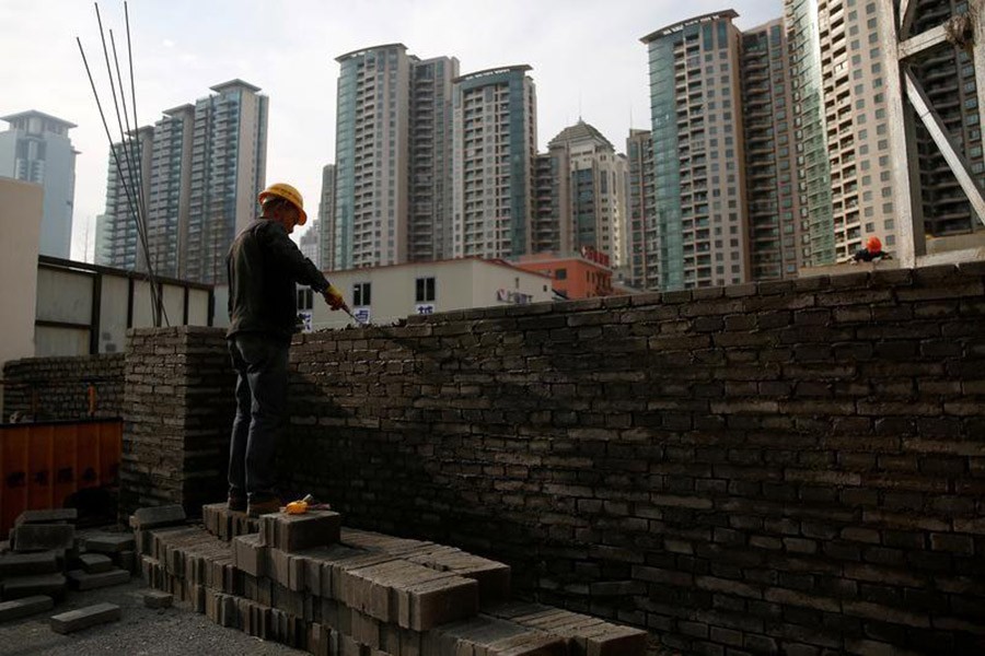 A worker works at a construction site in China on March 3, 2017.  - Reuters file photo