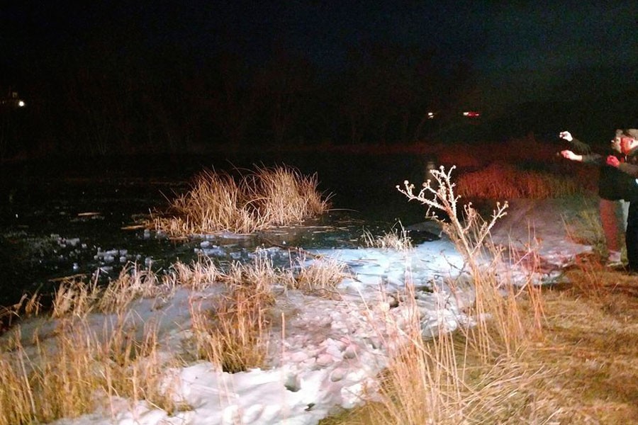 A search and rescue team work on the edge of a frozen pond in New Harmony, Utah on Dec 25, 2017. (AP Photo)