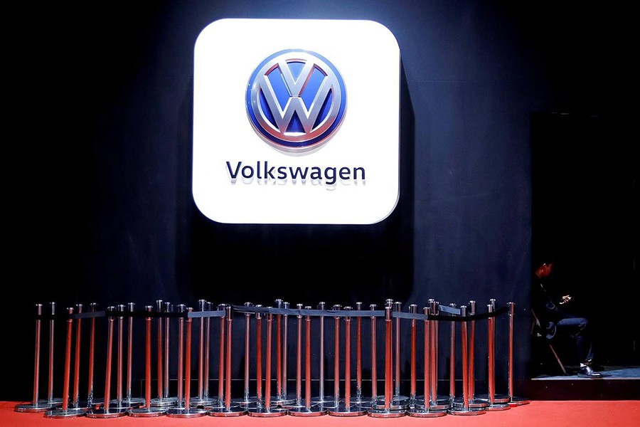 A man uses phone under a Volkswagen logo at the Shanghai Auto Show, in Shanghai, China on April 20 last. - Reuters file photo