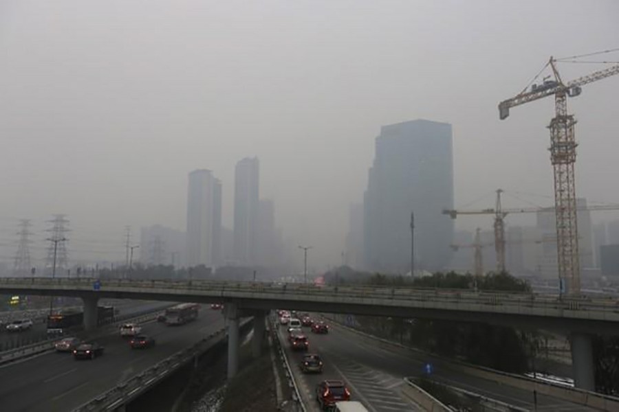 Vehicles drive towards the Central Business District (CBD) amid heavy smog in Beijing, China on November 28, 2015. - Reuters file photo