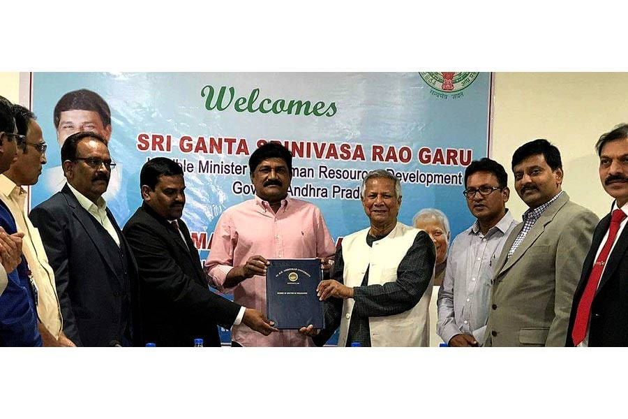 Nobel Laureate Professor Muhammad Yunus exchanging the MoU documents for establishment of YSBC with BRAU Vice-Chancellor Koona Ramji in the presence of Minister of Human Resources Development of Andhra Pradesh, Mr. Ganta Srinivasa Rao in Guntur, India