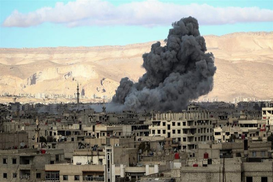 GHOUTA: Smokes billowing from an area in Eastern Ghouta after an air stike on Wednesday.	— Reuters