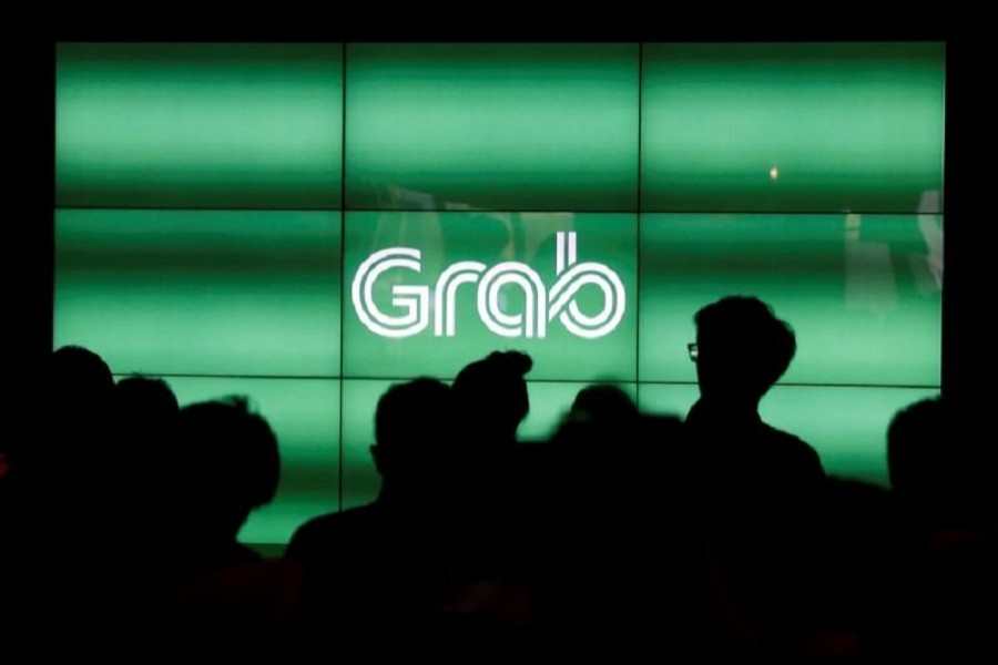 People wait for the start of ride-hailing company Grab's fifth anniversary news conference in Singapore June 6, 2017. Reuters/File Photo