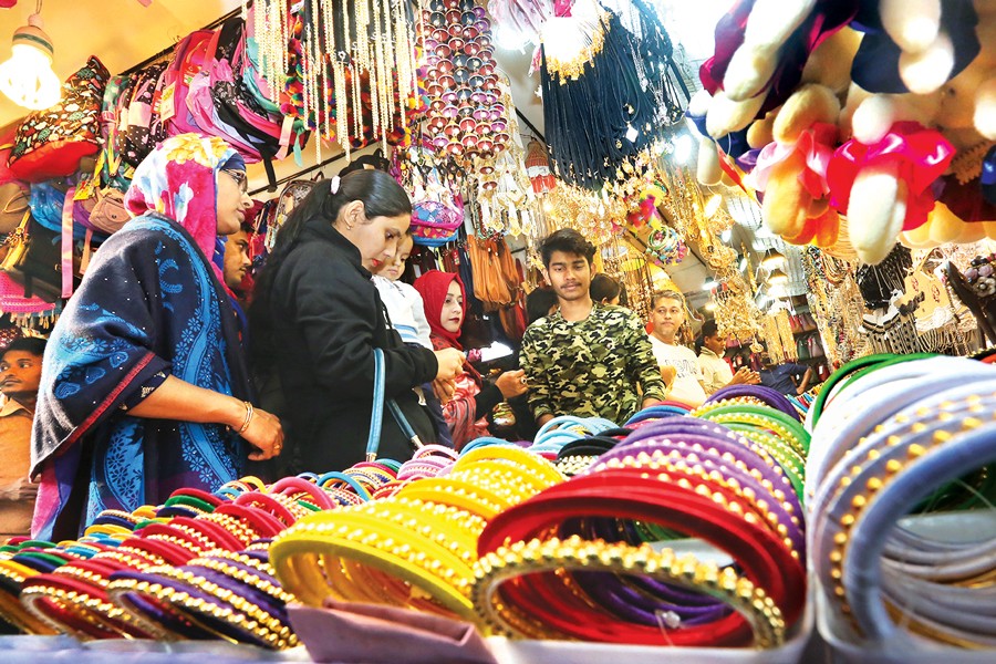 The ongoing Dhaka International Trade Fair gained life on Friday being weekend. Visitors seen swarming a stall to snap up imitation ornaments. 	— FE Photo by KAZ Sumon