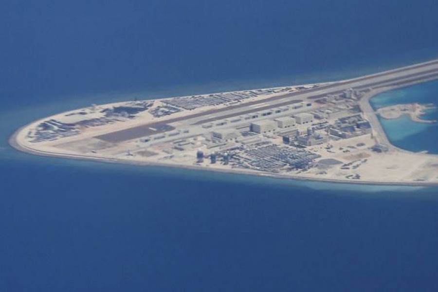 An airstrip, structures and buildings on China’s man-made Subi Reef in the Spratly chain of islands in the South China Sea are seen from a Philippine Air Force C-130 transport plane of the Philippine Air Force.  - AP photo