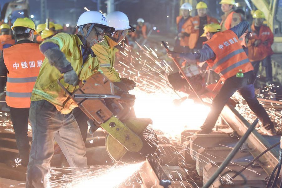 Workers work at the construction site of Longyan railway station to join three existing railways to a new railway linking Nanping and Longyan in Longyan City of southeast China's Fujian Province. 	— Xinhua