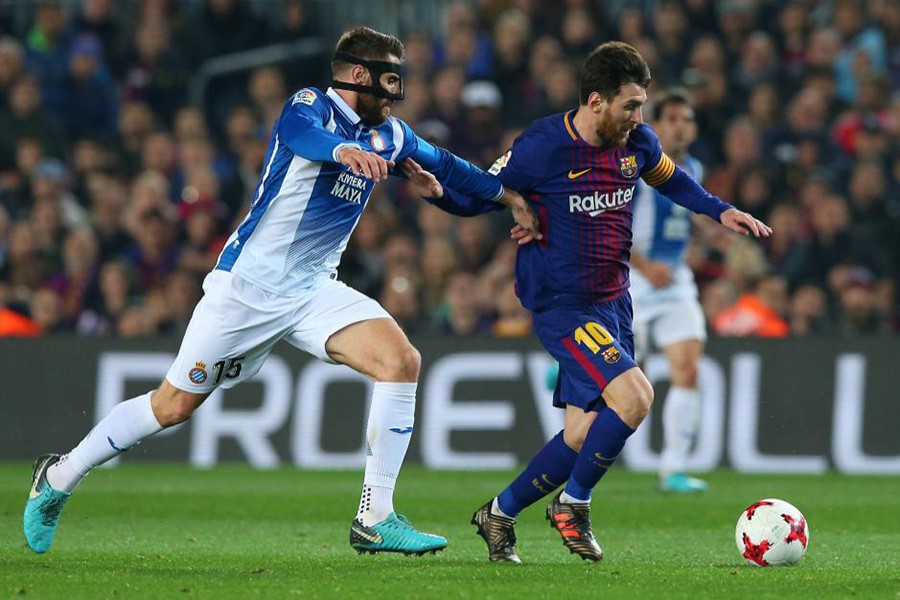 Barcelona’s Lionel Messi in action with Espanyol’s David Lopez. - Reuters photo