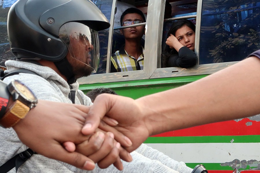 When protests defy passenger woes: Passengers in bus cut dejected figures as they remained stuck in heavy gridlock near the Nilkhet-New Market intersection in the city on Saturday when students of seven colleges affiliated with Dhaka University (DU) formed a human-chain demanding specific subject allocation immediately. The hour-long agitation resulted in a complete standstill of the city traffic. - FE photo by Shafiqul Alam