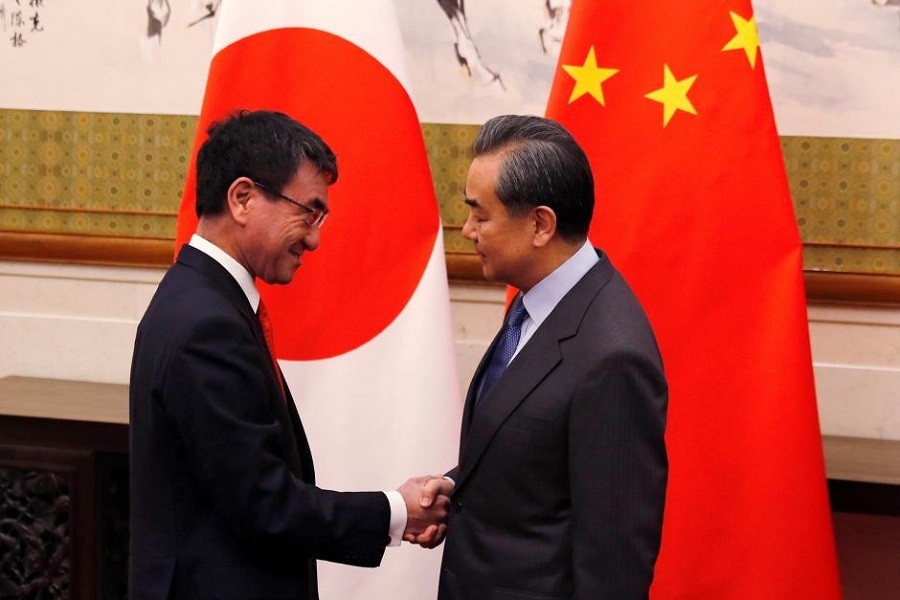 Japanese Foreign Minister Taro Kono, left, and Chinese counterpart Wang Yi pose for photograph before their meeting at the Diaoyutai State Guesthouse in Beijing, China January 28, 2018. Reuters