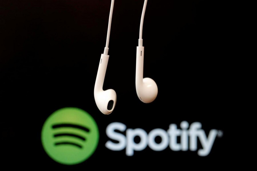 Headphones are seen in front of a logo of online music streaming service Spotify in this February 18, 2014 illustration picture. Reuters/File Photo