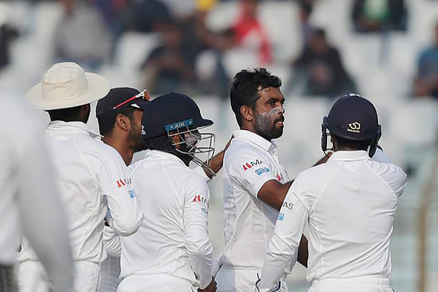 Sri Lanka's Dilruwan Perera, second right, celebrate with his teammates the dismissal of Bangladesh's Imrul Kayes during the fourth day of Chittagong Test.