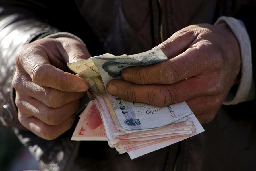 A vegetable vendor counts his money at a market in Beijing, China on March 10, 2016. - Reuters file photo used for representation.