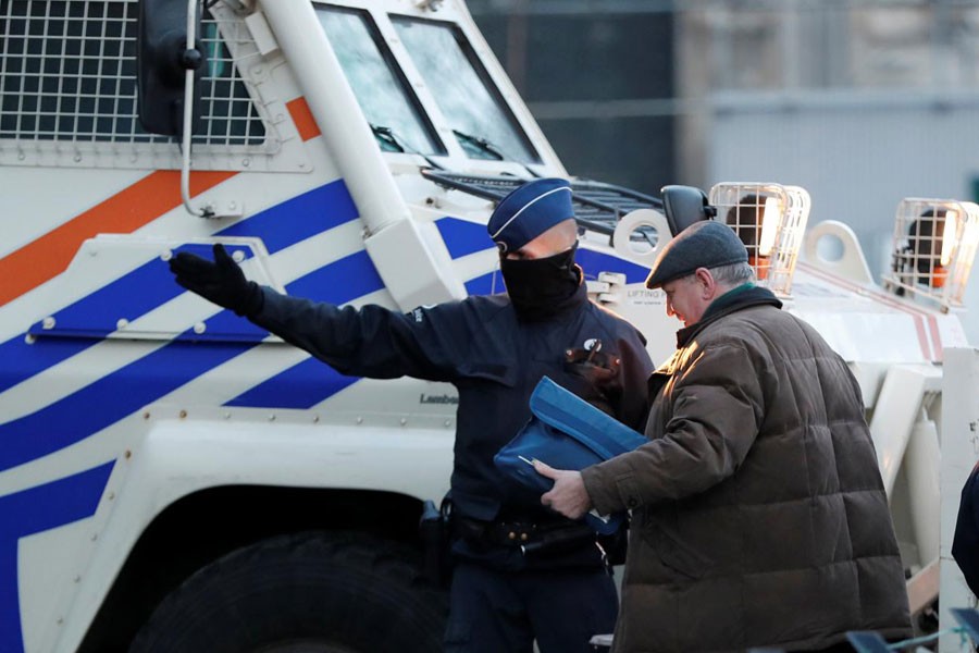 Police officers check visitors at the entrance of the courthouse ahead of the trial of Salah Abdeslam, one of the suspects in the 2015 Islamic State attacks on Paris. (Reuters)