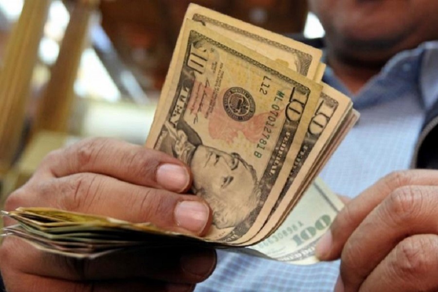 A man counts US dollars and Euros at a money changer office in central Cairo, Egypt, December 27, 2016. Reuters/File Photo