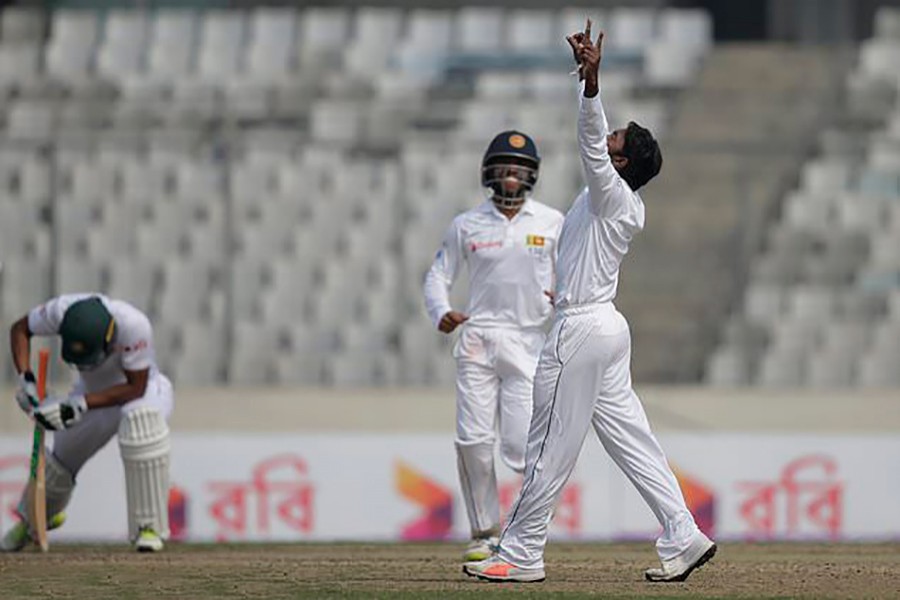 Sri Lanka's Akila Dananjaya, right, celebrates the dismissal of Bangladesh's captain Mahmudullah, left, during the second day of the second and final test cricket match at Mirpur stadium on Friday. - AP photo