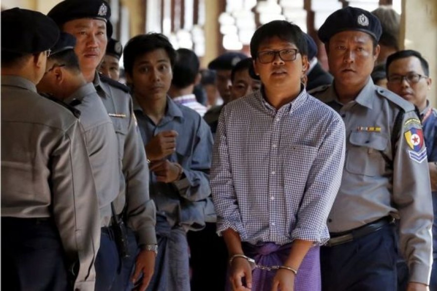 Kyaw Soe Oo (centre left) and Wa Lone (centre right) were arrested in December. - EPA