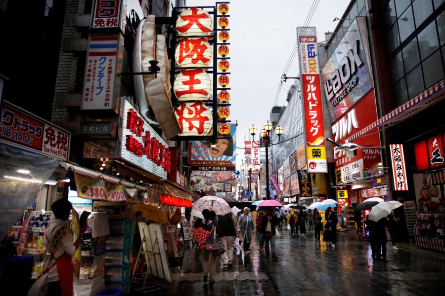 People walk through a shopping district in Osaka, western Japan October 22, 2017. Reuters